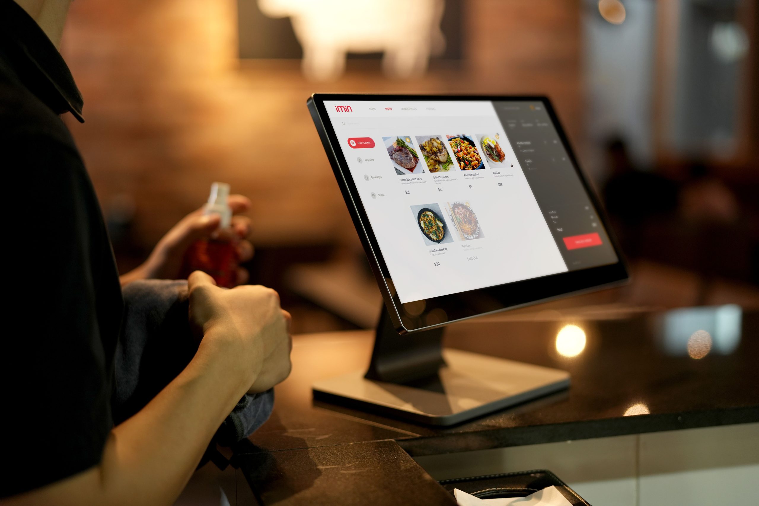 Customer using a self-order touchscreen kiosk in a restaurant