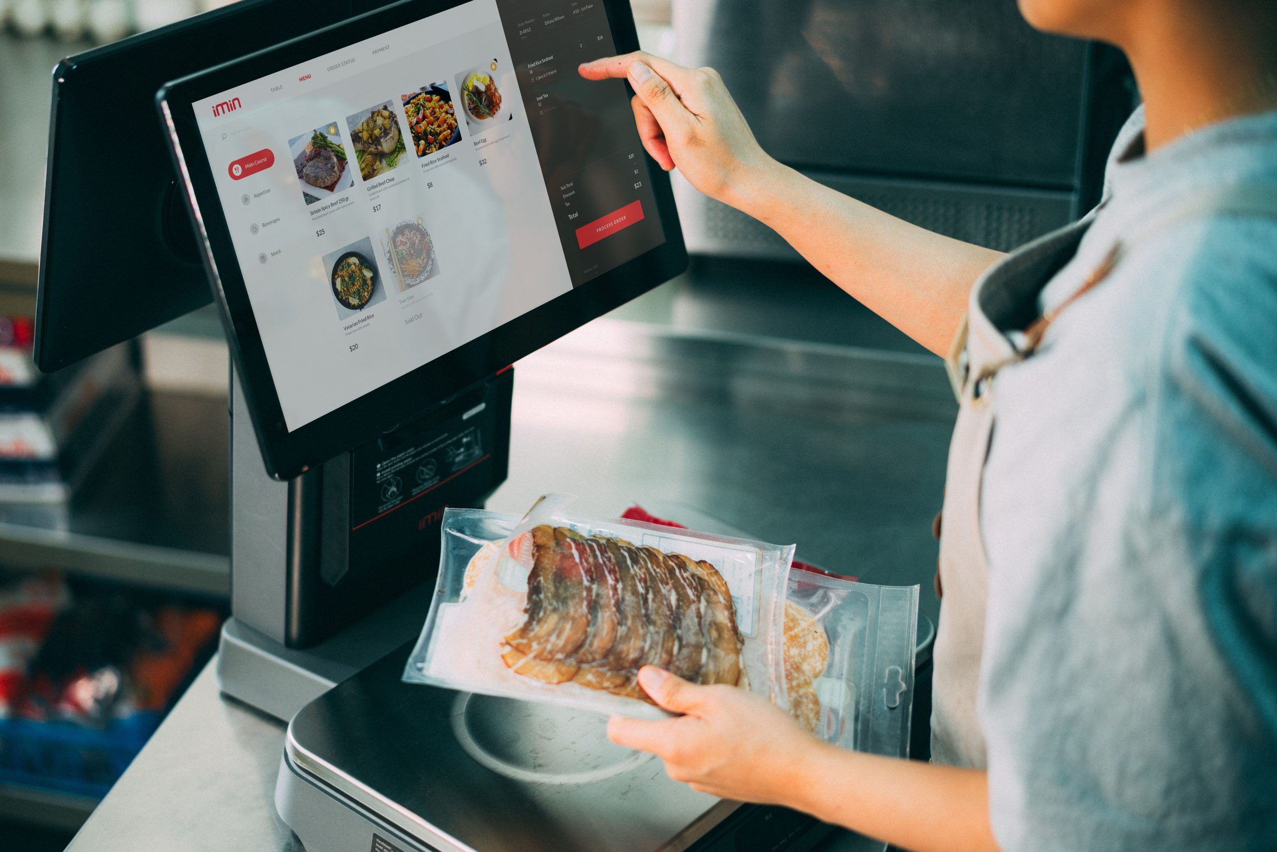 Person paying at a digital POS counter for food