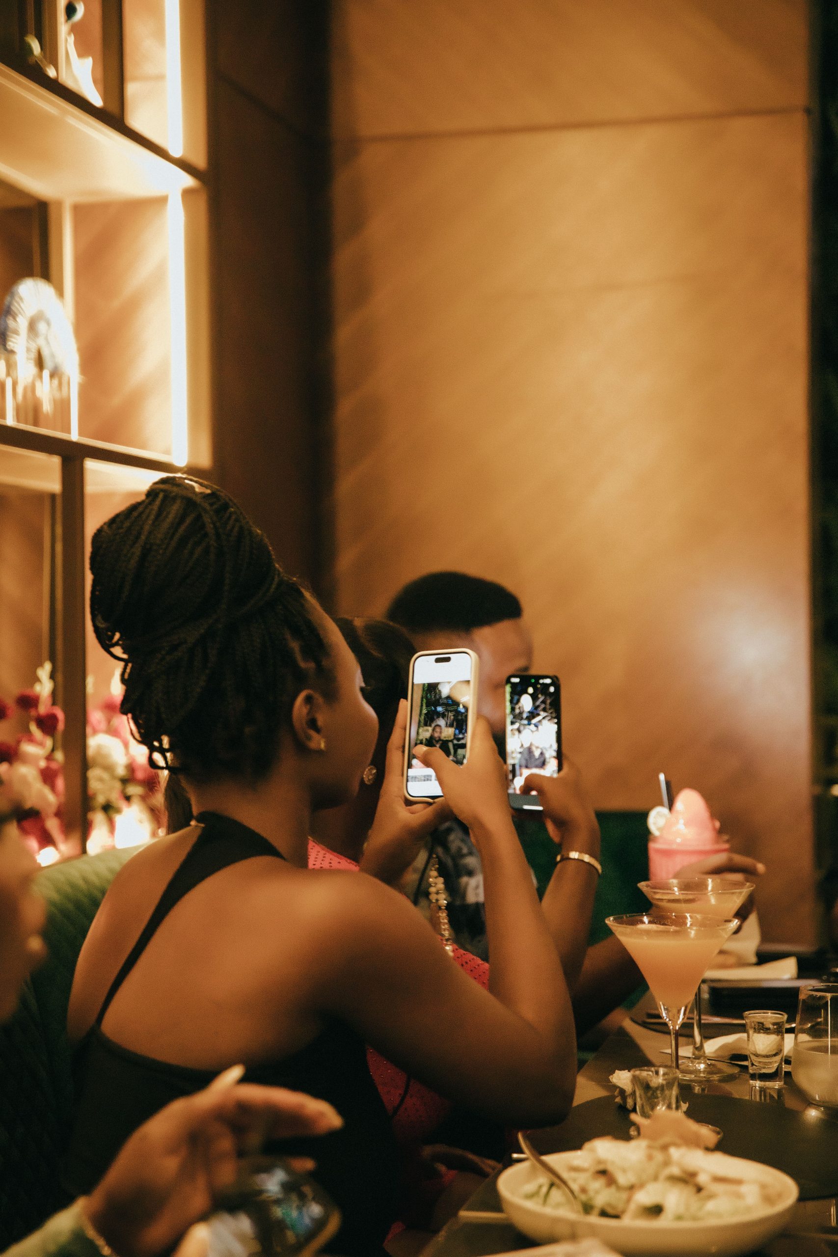 Customer at a restaurant table holding a smartphone
