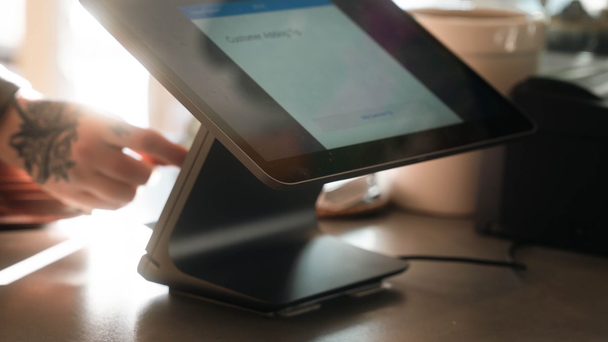 Modern restaurant POS tablet terminal on a counter
