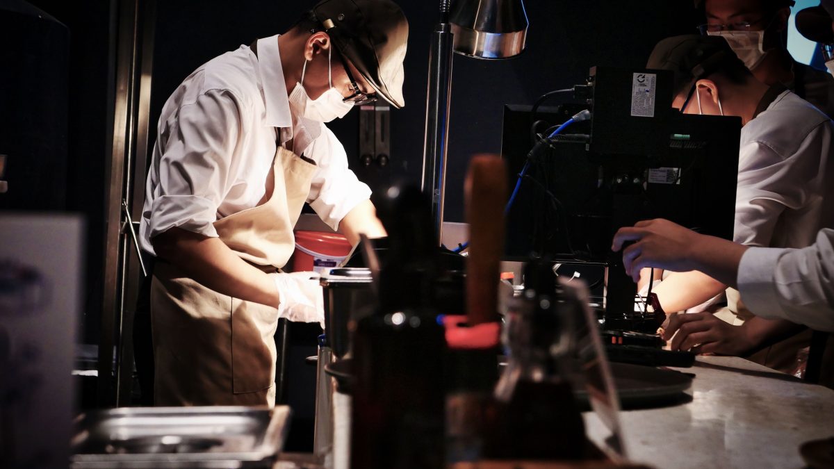 Chefs working together in a busy restaurant kitchen