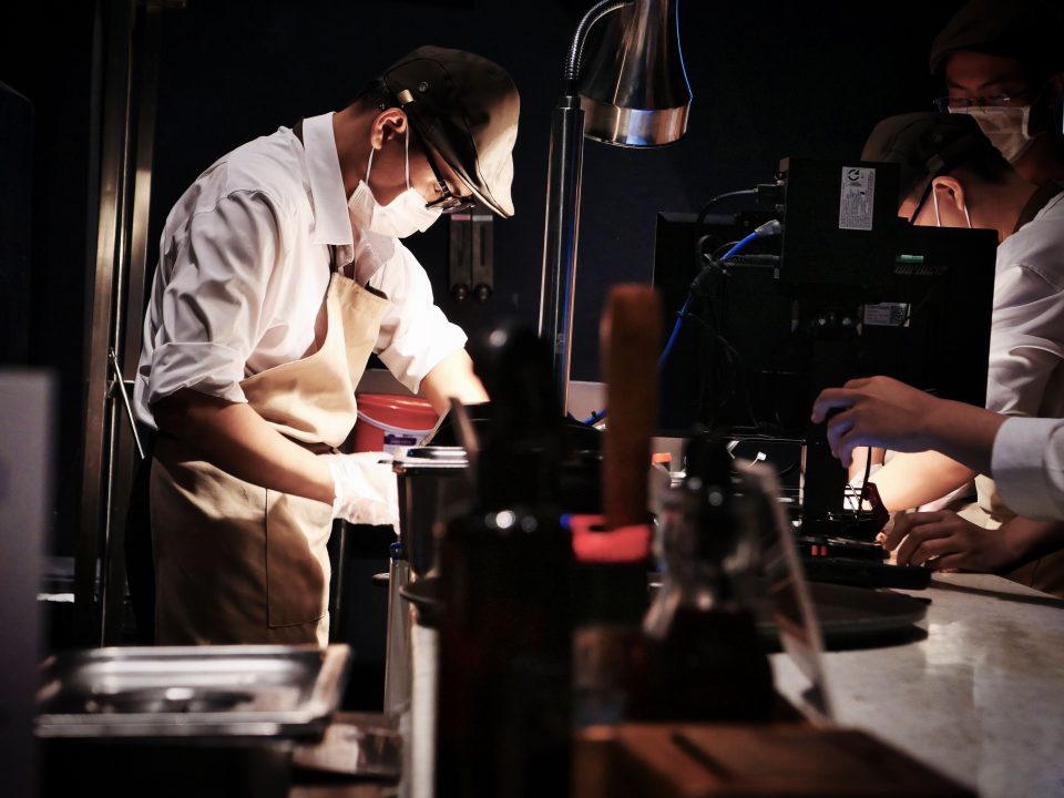 Chefs working together in a busy restaurant kitchen