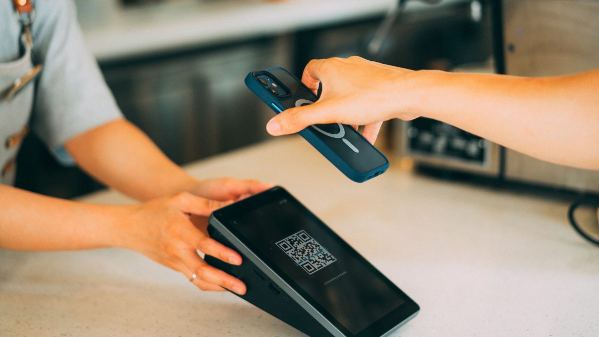 Close-up of a person scanning a barcode at a retail checkout
