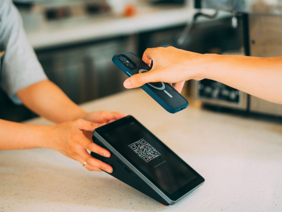 Close-up of a person scanning a barcode at a retail checkout