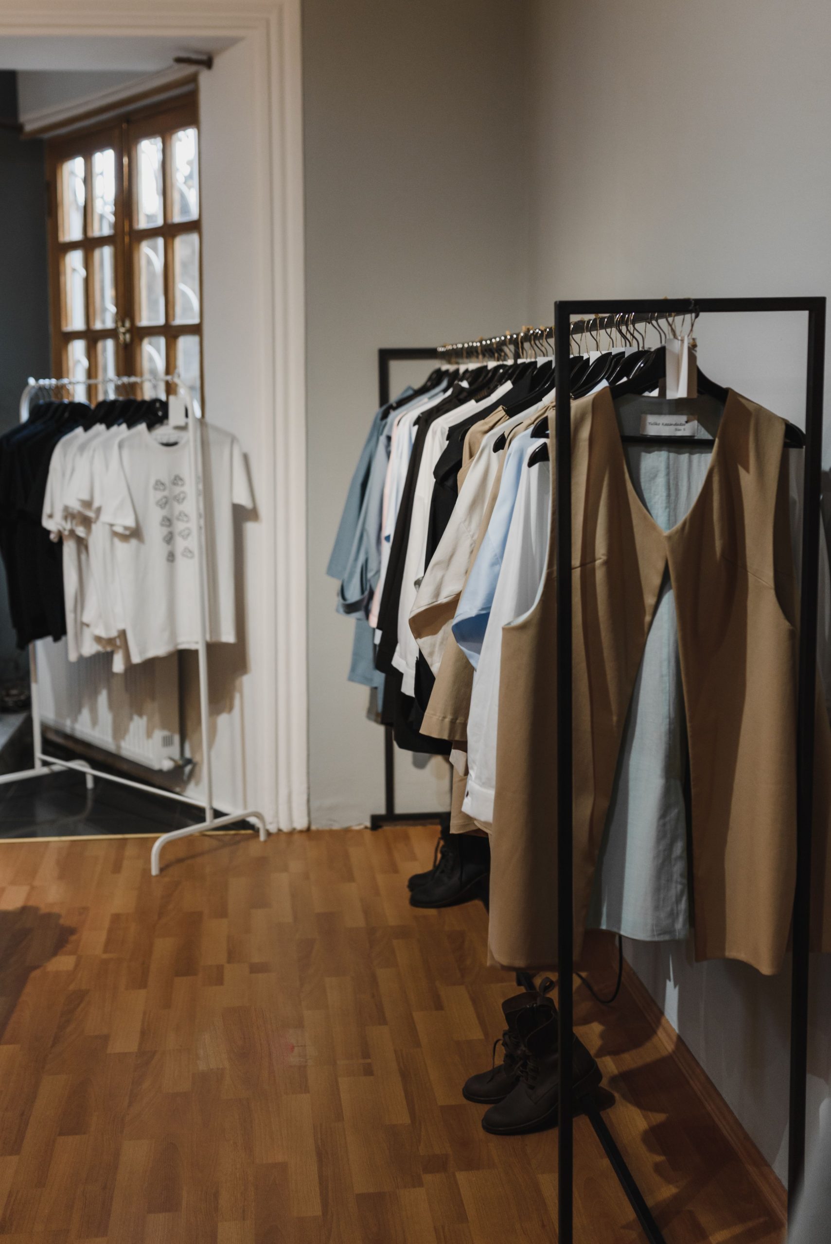 Indoor view of a boutique with clothing racks and SKU variants on hangers