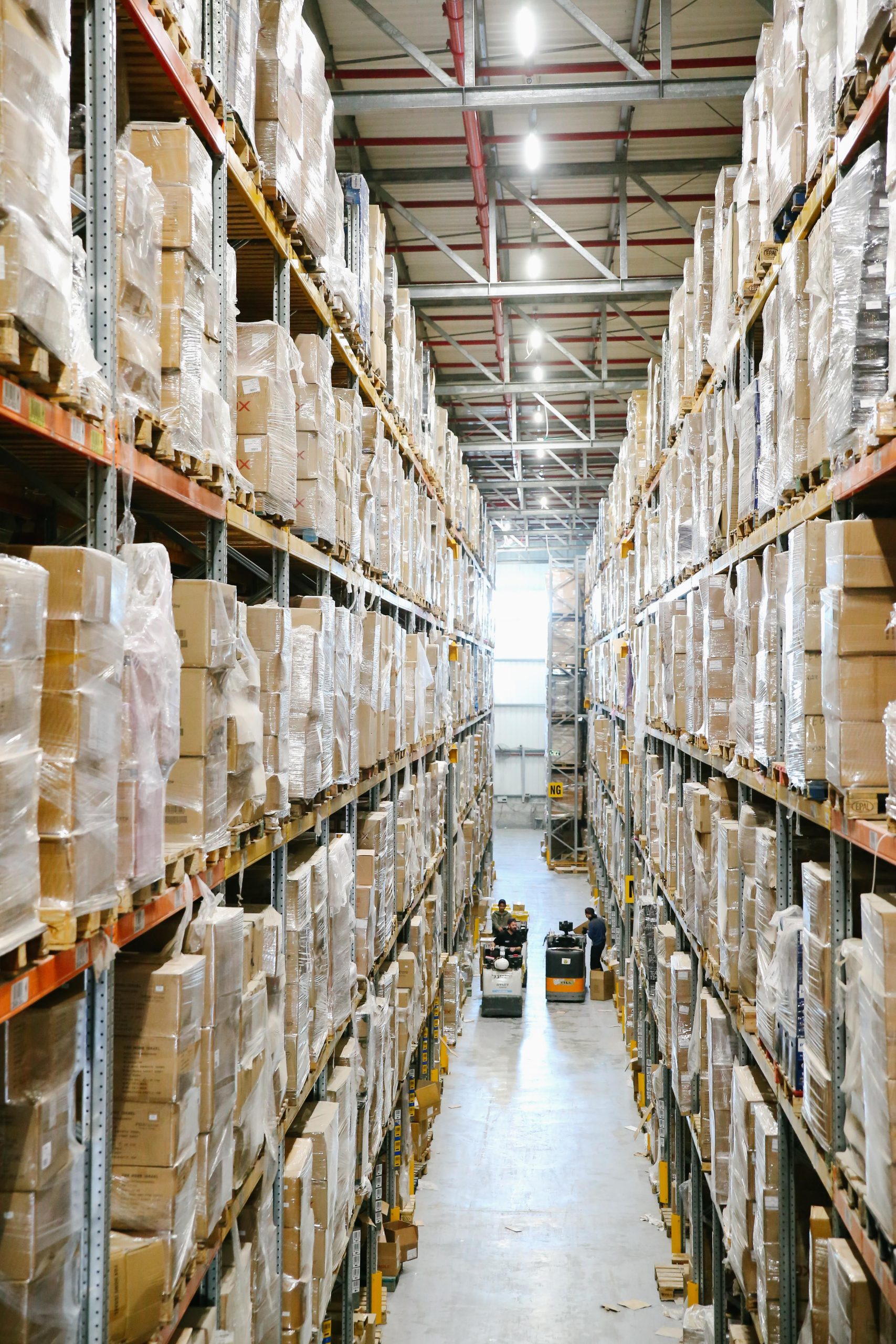 Warehouse aisle with shelves stacked with boxes for stock transfers