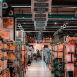 Bustling supermarket aisle with shoppers and stocked shelves