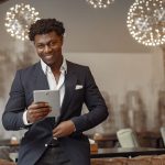 Restaurant manager reviewing sales data on a tablet in a cafe