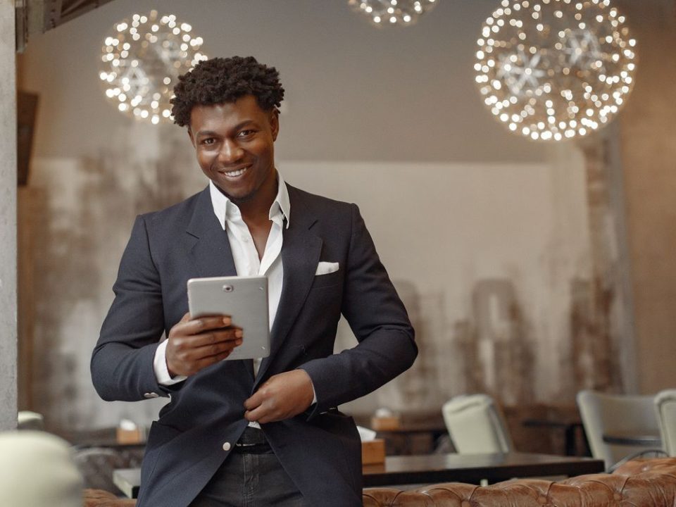 Restaurant manager reviewing sales data on a tablet in a cafe