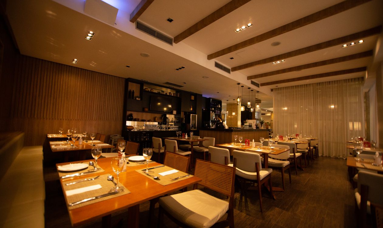 Set tables in an empty restaurant dining room before service