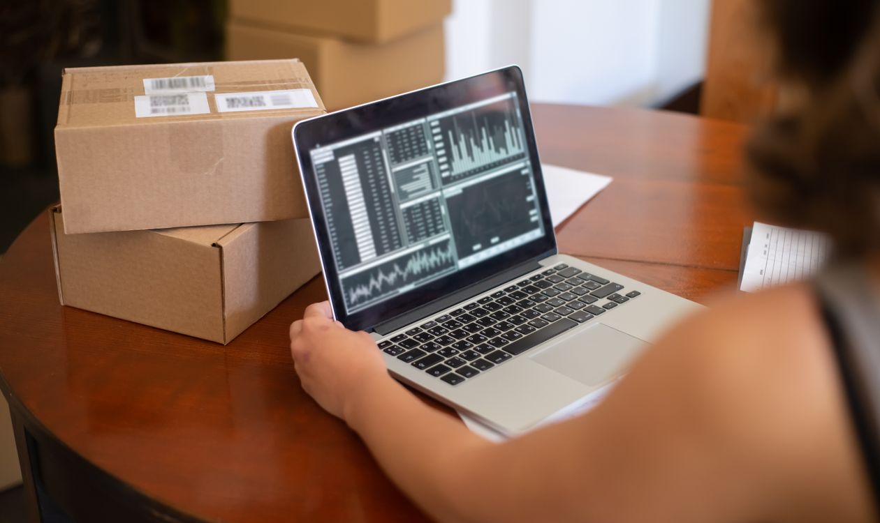 Business owner analysing sales charts on a laptop screen