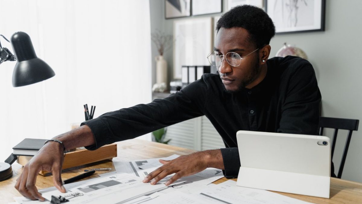 Business owner reviewing financial documents and reports at a desk