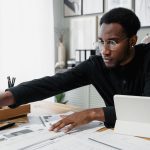 Business owner reviewing financial documents and reports at a desk