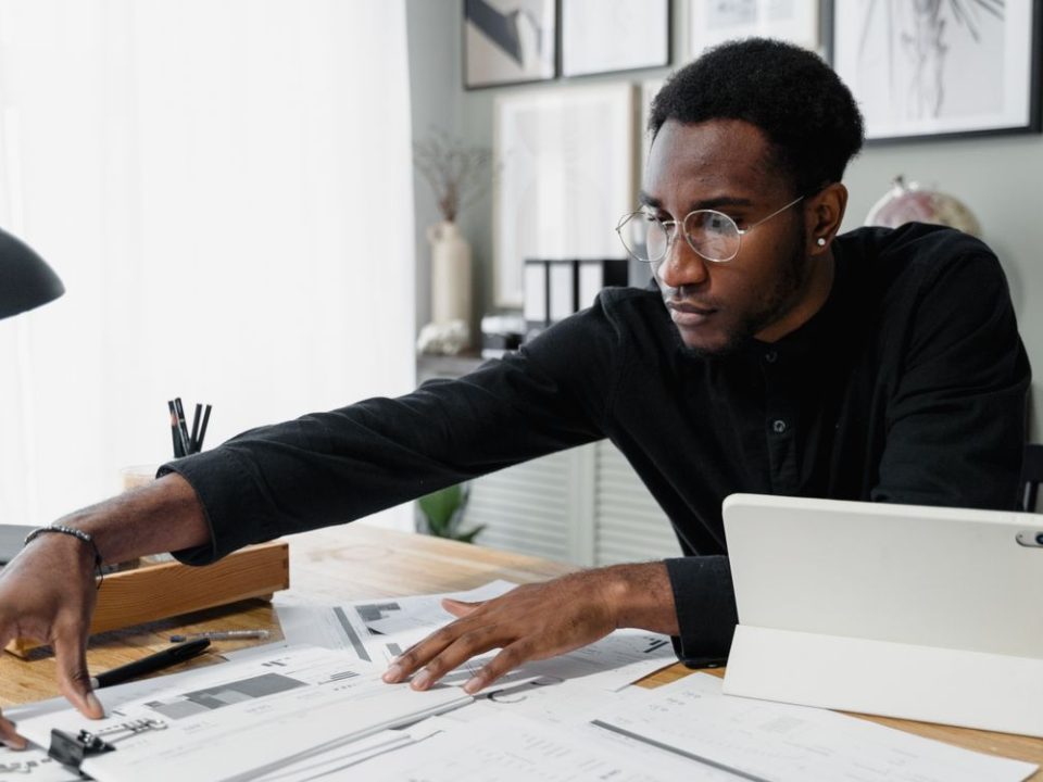 Business owner reviewing financial documents and reports at a desk